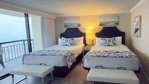 A hotel room with two beds, a bench, a nightstand, and a view of the sea. - Two Pina Coladas At San Luis Resort 2 Bedroom Condo (Galveston)