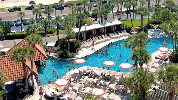 A resort with a large swimming pool, beach, and parking area. - Two Pina Coladas At San Luis Resort 2 Bedroom Condo (Galveston)
