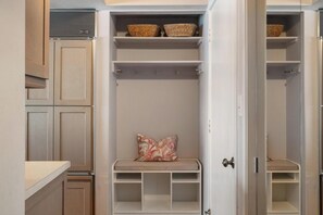 A walk-in closet with open doors, shelves, and baskets. - 4BR Pool Access, Near Nubs Nob and Petoskey (Harbor Springs)