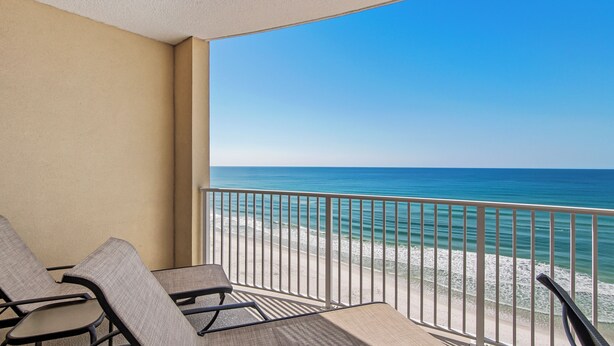 A balcony with two chairs and a view of the beach and ocean. - Emerald Isle 1102 - Front row beach chair service included! Affordable rates! (Panama City Beach)
