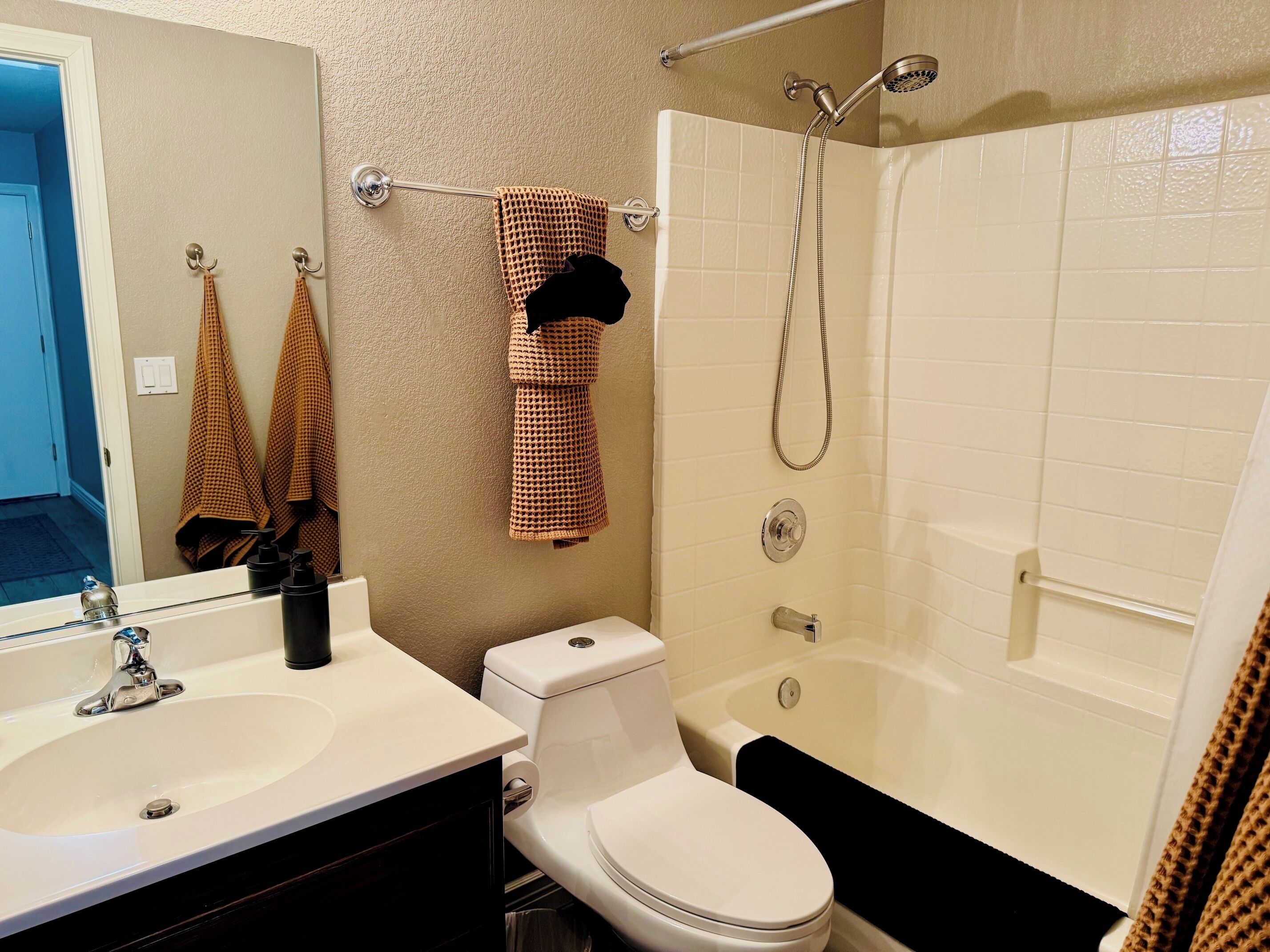 A bathroom with a sink, toilet, and bathtub.