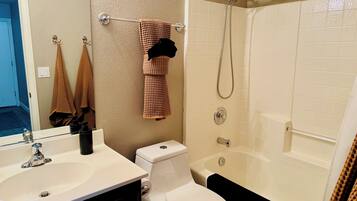 A bathroom with a sink, toilet, and bathtub.
