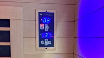 A digital control panel with time and temperature settings, a power button, and a lock function.