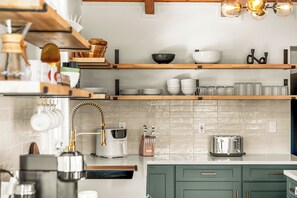 A modern kitchen with wooden shelves, a coffee machine, and a toaster. - Cozy 2 BR Wellness Cabin in Bailey, Yoga, Sauna, Mountain Views (Bailey)