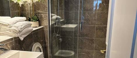 Shower, hair dryer, towels, soap