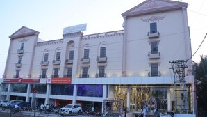 A multi-story building with a classical architectural style, featuring a central entrance with a decorative archway. - THE CROWN TOWN BIDAR (Bidar)