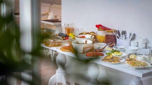A breakfast buffet with various food items and utensils. - Boutique Hotel Meidan View (Tbilisi)