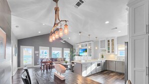 A spacious kitchen with a large island, modern appliances, and pendant lighting. - Seashell Shack on Shrimp, Sleeps 11 - 3 bedroom 2.5 Bath - Great View (Crystal Beach)