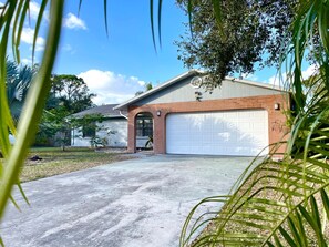 A residential garage with a brick exterior and a white garage door. - Sarasota Family Home Private Heated Pool Relax (Sarasota)