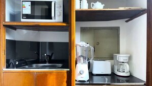 A compact kitchen with a microwave, toaster, blender, and coffee maker. - La Platea de Bs As [7A] Views of the Libertad Palace (Buenos Aires)