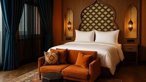 A bedroom with a large bed, a sofa, and two wall-mounted lamps. - Le Marrakech Boutique Hotel (Kleinblittersdorf)