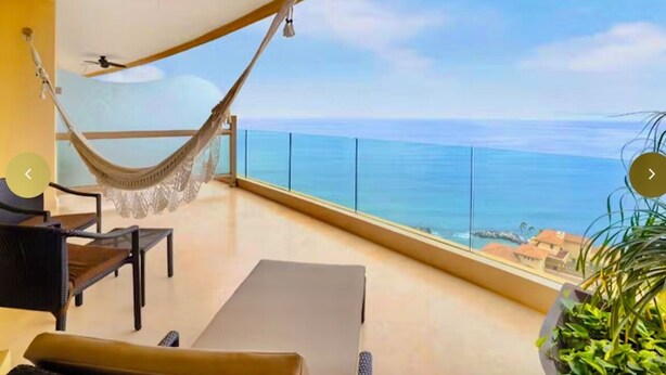 A balcony with a hammock, a sofa, and a view of the ocean. - Magnificent Ocean view suite with private balcony jacuzzi (Puerto Vallarta)