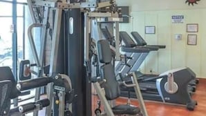A gym with various exercise machines, including a squat rack and treadmills. - Charming Ever Green 2-Bedroom Condo in Sugar Mountain with Resort Amenities (Sugar Mountain)