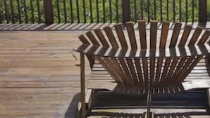 A wooden deck with a view of a mountainous landscape. - Charming Ever Green 2-Bedroom Condo in Sugar Mountain with Resort Amenities (Sugar Mountain)