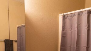 A bathroom with a toilet, sink, and a shower curtain. - NDSU Efficiency (APT 3) (Fargo)