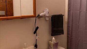 Shower, hair dryer, towels, shampoo