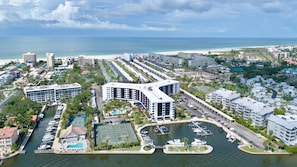 A coastal hotel with a marina, tennis courts, and a beach view. - Harbor Towers 614 - Tropical Sands Accommodations (Siesta Key)