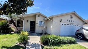 A single-story house with a garage, a front door, and a small porch. - Charming Villa House 3-bedroom with pool & jacuzzi, AC in beautiful San Marcos (San Marcos)
