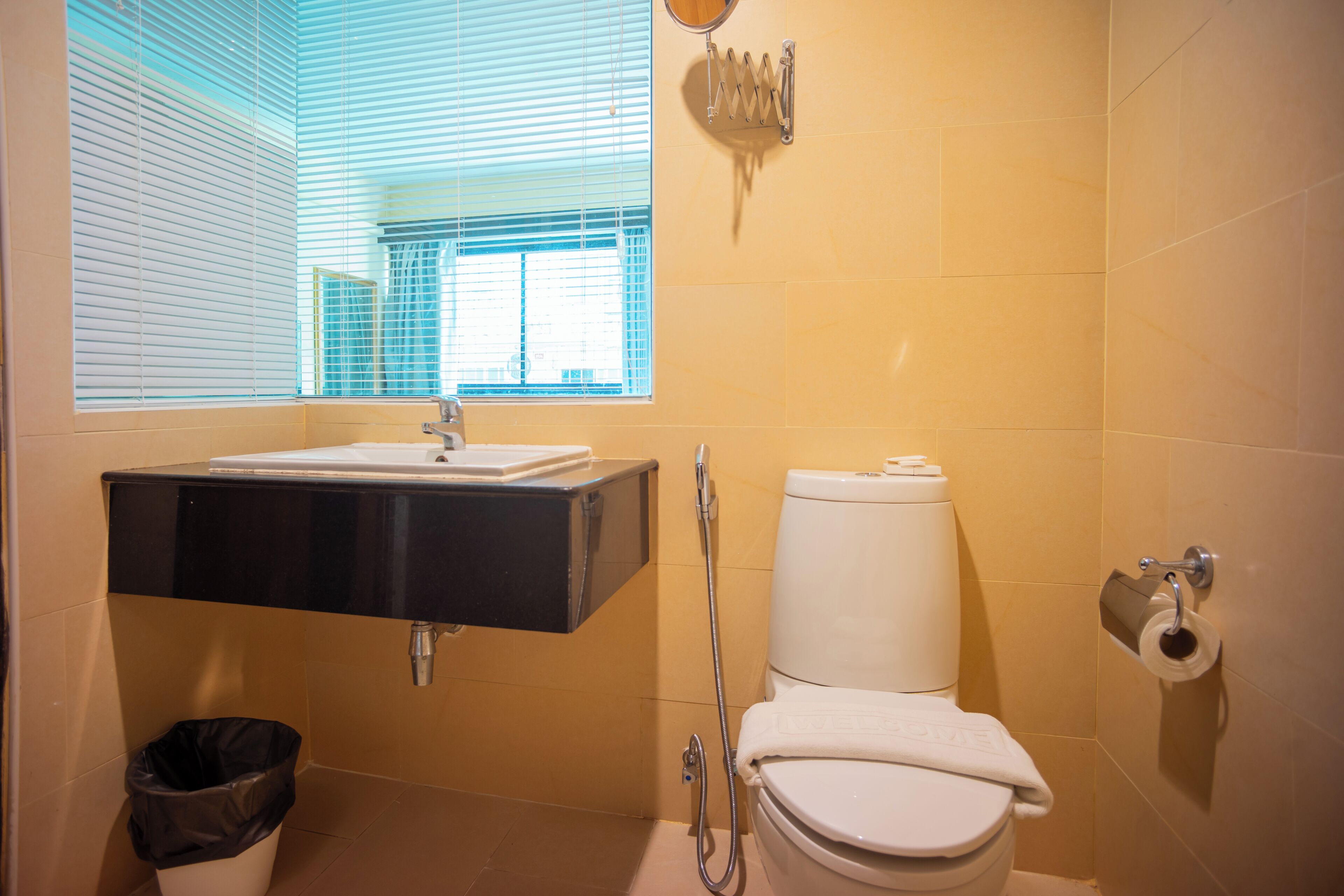 A bathroom with a sink, toilet, and shower.