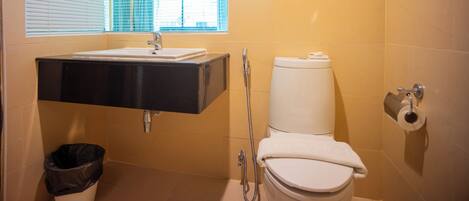 A bathroom with a sink, toilet, and shower.