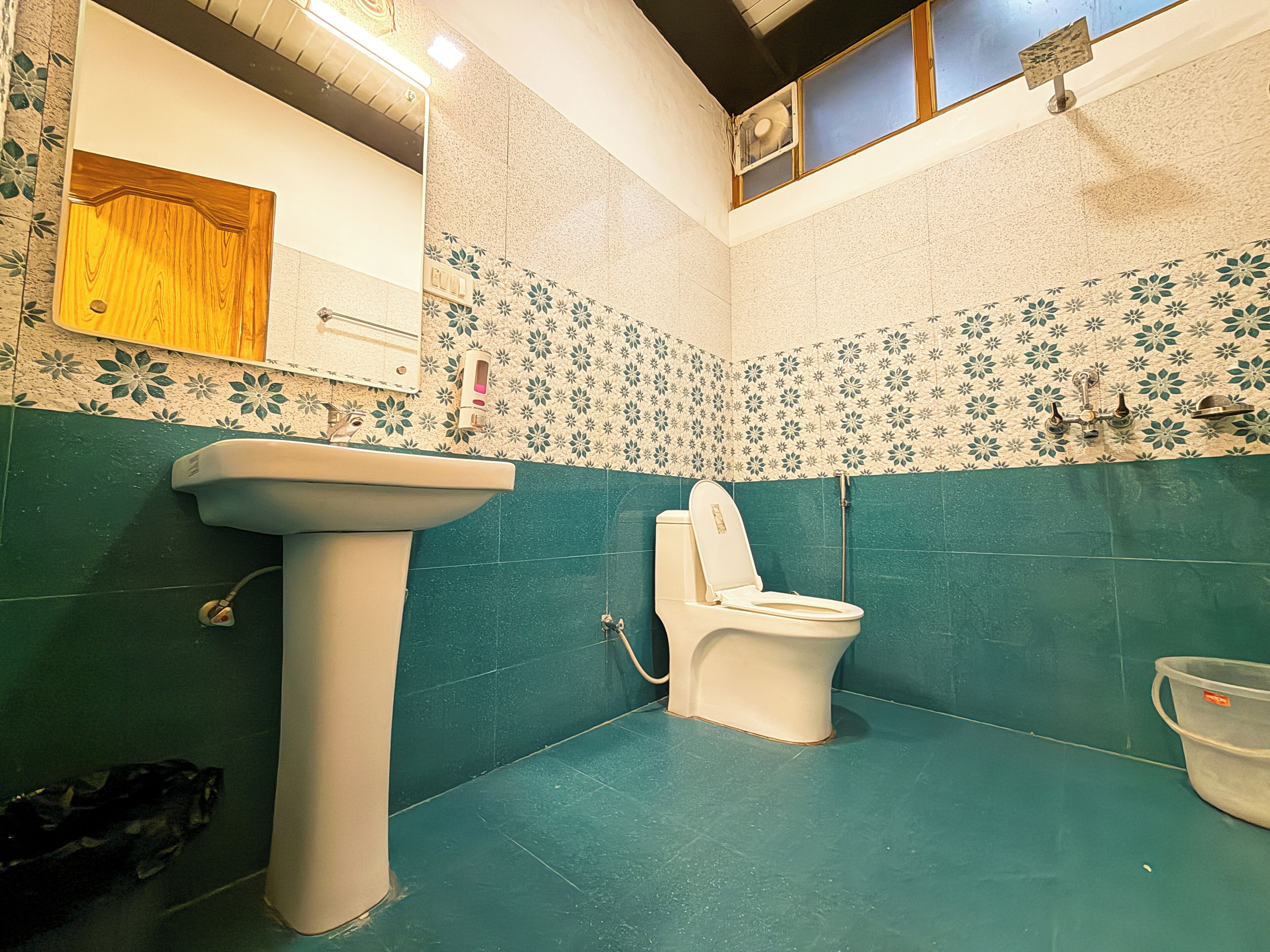 A bathroom with a sink, toilet, and shower.