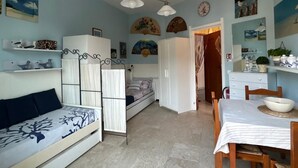 A compact living space with a bed, a sofa, a dining table, and a kitchen area. - Cozy accommodation a short walk from the sea and downtown with private parking space (Finale Ligure)