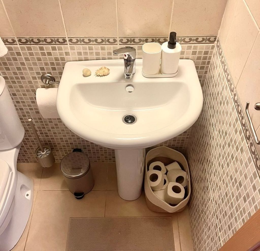 A bathroom with a sink, toilet, and bidet.