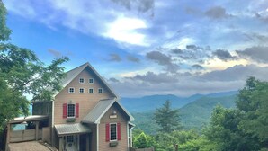 A two-story house with a sloped roof, a front porch, and a view of mountains. - Hidden Gem in the Smokies - Awenasa (Franklin)