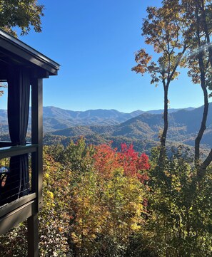 A view from a balcony with a mountain range in the background and autumn foliage. - Hidden Gem in the Smokies - Awenasa (Franklin)