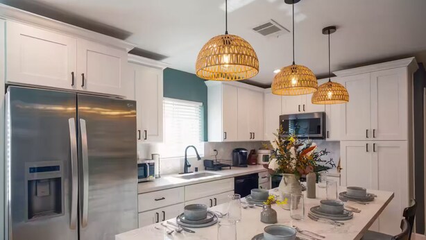 A modern kitchen with white cabinets, stainless steel appliances, and a marble countertop. - Charming Detached Bungalow in Historic Old Town Monrovia Kingsize Bed！ (Monrovia)