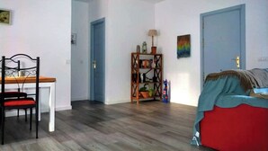 A room with a bed, a desk with a chair, a bookshelf, and a door. - Rural house in the middle of nature (Chiclana de la frontera)