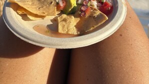 A plate of nachos with avocado and salsa on a beach. - Luxury Studio & 1BR Condos • Pools • Near Tulum & Akumal Beaches (Akumal)