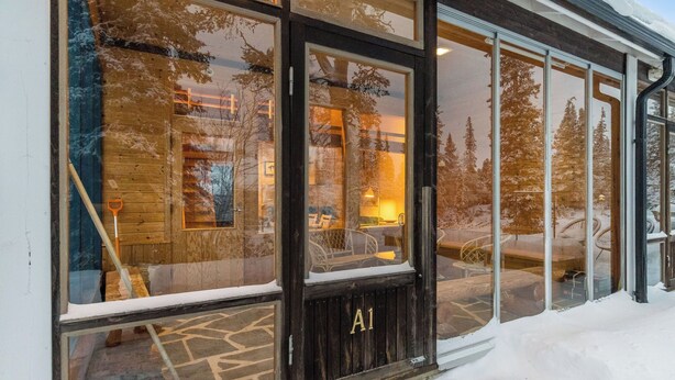 A wooden exterior with large windows and a door labeled "A1". - Lupponen by Interhome (Inari)