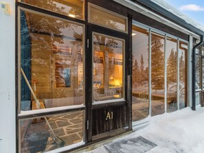 A wooden exterior with large windows and a door labeled "A1". - Lupponen by Interhome (Inari)