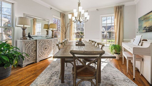 A dining room with a wooden table, chairs, a chandelier, and a piano. - New! Fig Tree House! Near Downtown, Hot Tub, 3 Kings, Pets/Family/Work Friendly (Greenville)