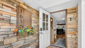 A stone wall with a wooden door and a number '1610' sign. - Canalfront 3BR Heated Pool With Boat Lift (Punta Gorda)