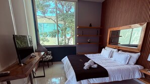 A modern bedroom with a bed, a desk, a TV, and a large window. - Beautiful apartment with a private Jacuzzi (Jal.)