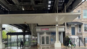 A building with a covered entrance, a sign for 'Kedzie,' and a parked scooter. - 2 Bedroom apartment free parking near transit (Chicago)