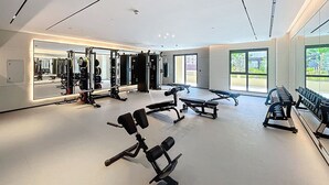 A spacious gym with various exercise equipment, large windows, and a clean, modern design. - Luxury Living 1 Bed l Pool View l Burj Al Arab (Madinat Jumeirah Living)