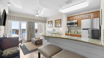 A modern kitchen with granite countertops, stainless steel appliances, and wooden cabinets.