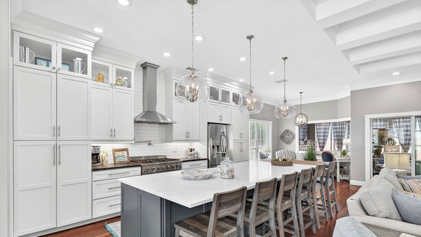 A spacious kitchen with white cabinets, a large island, and pendant lighting. - Golf Cart - Pool - Walk to Beach - Fully Remodeled - Crystal Beach - Sleeps 10 (Destin)