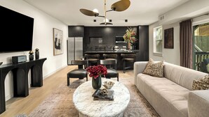 A modern living room with a marble coffee table, a beige sofa, and a black entertainment unit. - Resort-Style 4BR Ensuites •Slps11 •Pool&Spa •Gate (Houston)