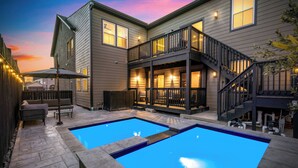 A two-story house with a backyard pool, outdoor seating, and a staircase leading to the upper level. - Resort-Style 4BR Ensuites •Slps11 •Pool&Spa •Gate (Houston)