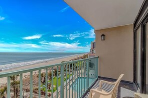 A balcony with a view of the beach and ocean. - Oceanfront Escape | Pools | Sleeps 4 (Myrtle Beach)