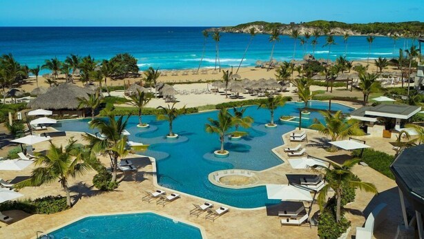 A resort with multiple swimming pools, palm trees, and beach views. - Dreams Macao Beach Punta Cana (Punta Cana)
