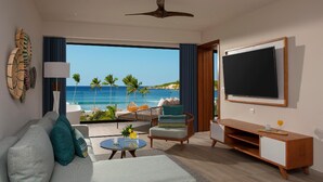 A modern living room with a large TV, comfortable seating, and a view of the ocean. - Dreams Macao Beach Punta Cana (Punta Cana)