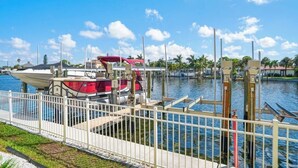 A marina with boats docked, a white fence, and a clear blue sky. - Pet Friendly, St. Pete Beach Condo w/AC, 1BR+Sofa Bed, Steps to Beach! (St. Pete Beach)