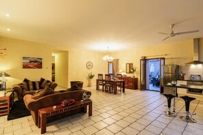 A living room with a sofa, coffee table, and dining area with chairs and a table. - Tranquil 2-bedroom cottage in cool Montels for a relaxing stay (Montels)
