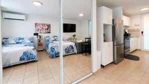 A modern apartment with a bedroom, a living area, and a kitchenette. - Golden Dream Studio 2nd floor B (Isabela)