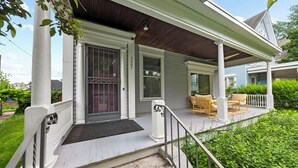 A porch with steps, a door, and a bench. - The Wunderhaus – 4BR Minneapolis Escape (Minneapolis)